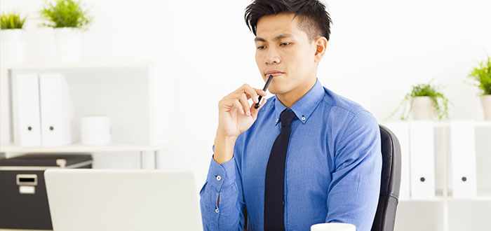 young business man watching laptop and planning 