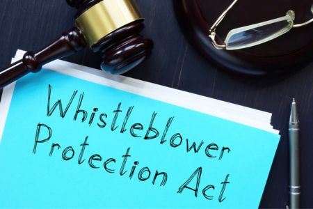 Lawyer desk with whistleblower protection act folder