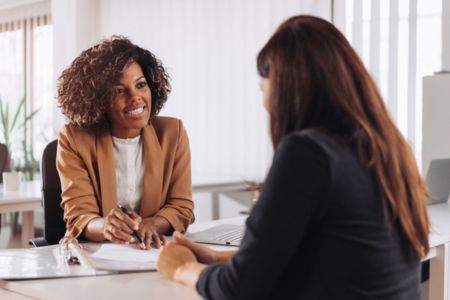 Two women at desk reviewing document