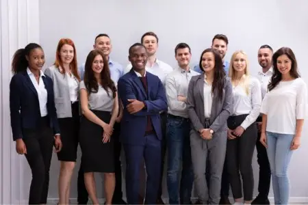 A diverse group of happy employees after a successful class action lawsuit